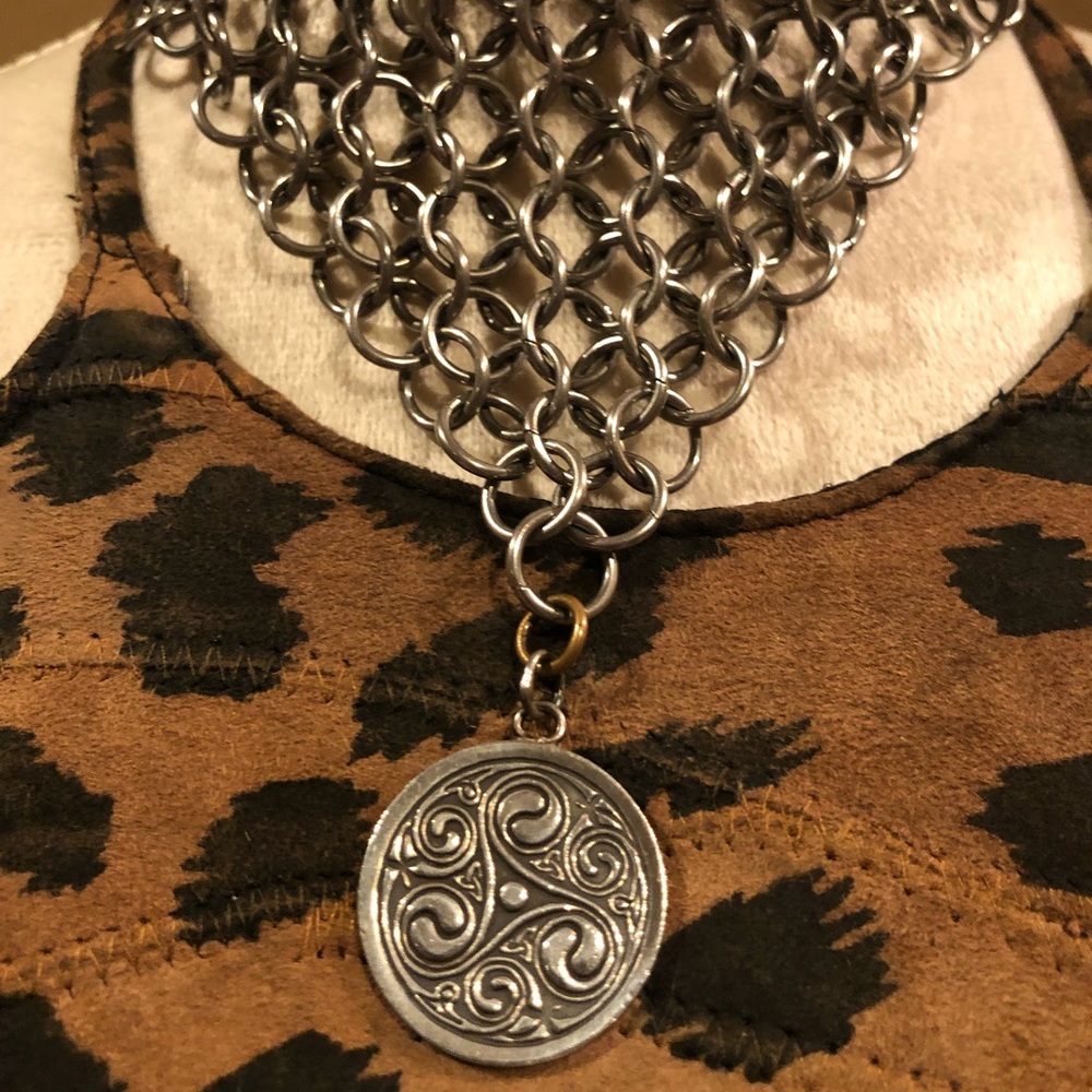 This is a silver medieval times type of choker necklace.